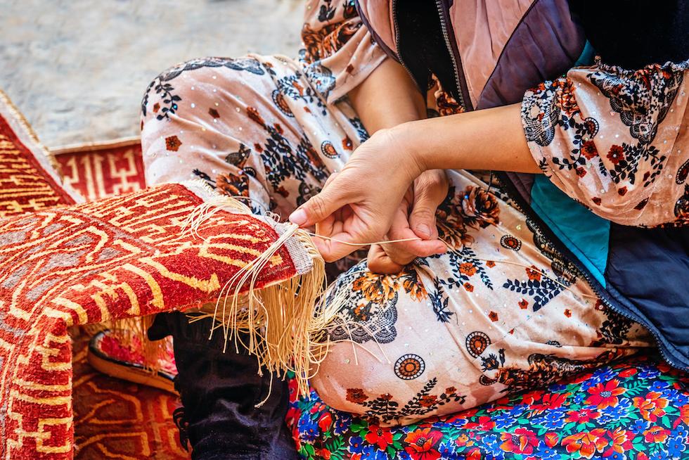 A woman weaving silk fabric. 